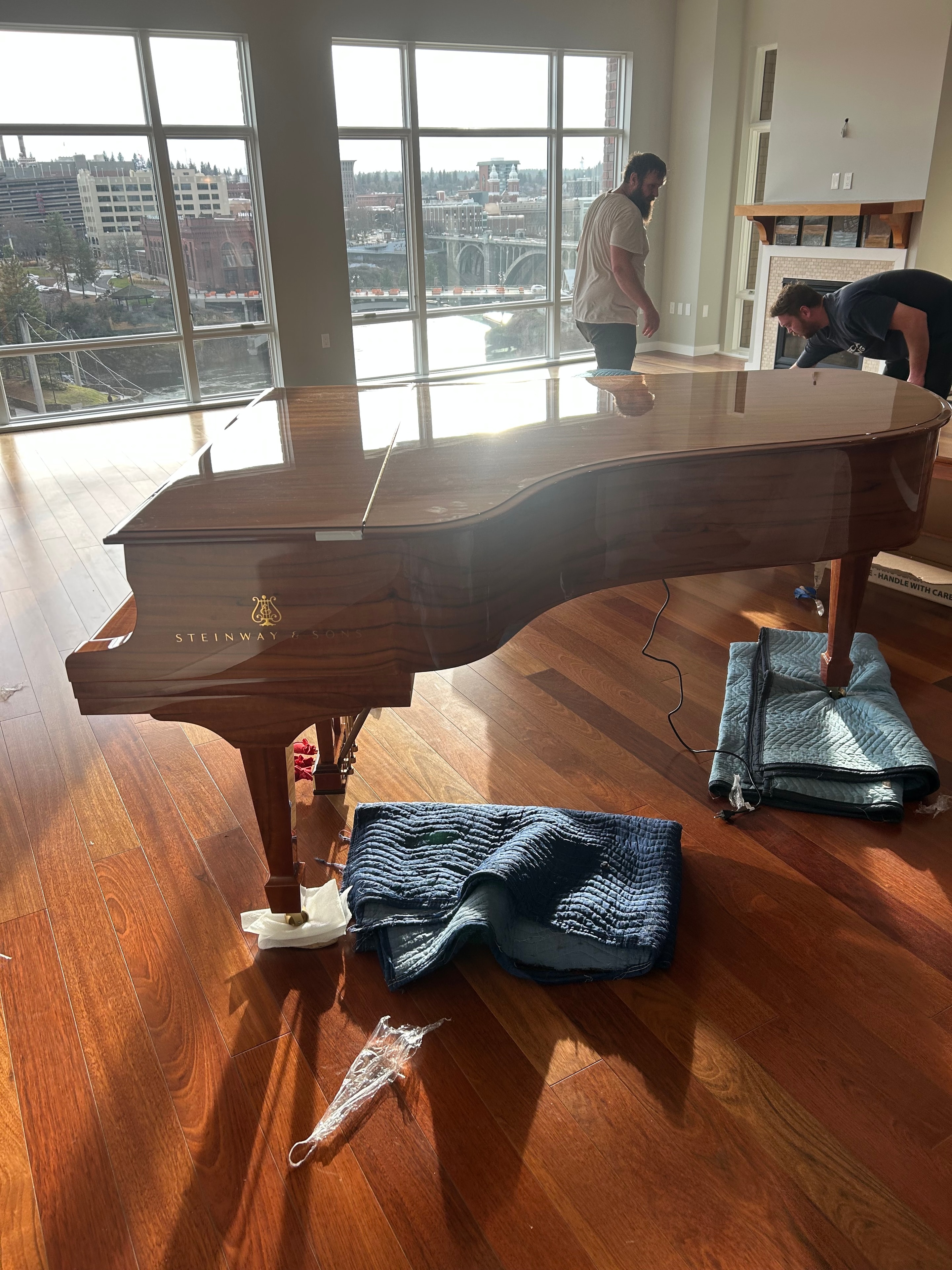 Steinway grand piano move in high-rise with Spokane city views