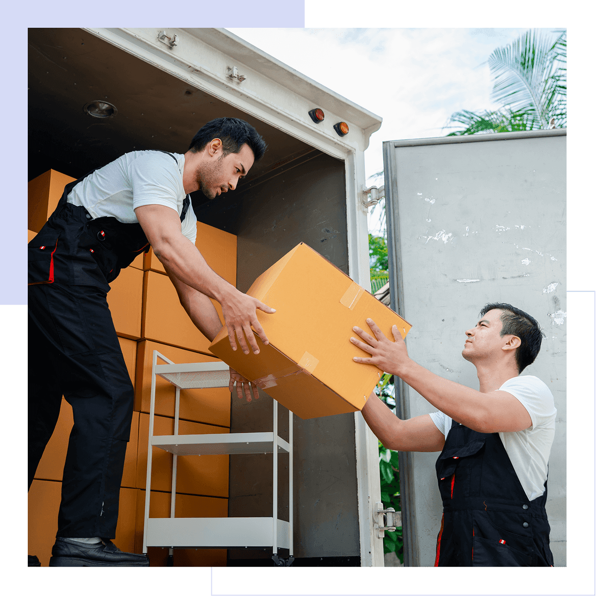Workers loading boxes into a truck.