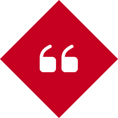 Red diamond with white quotation marks.